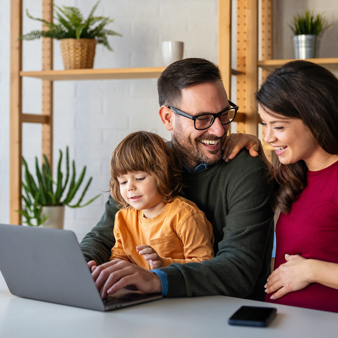 parents-and-child-relaxing-at-home-with-computer